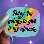 A hand holds up a sticker with a wavy rainbow in the background. Black text reads: Today I'm going to give it my almost.