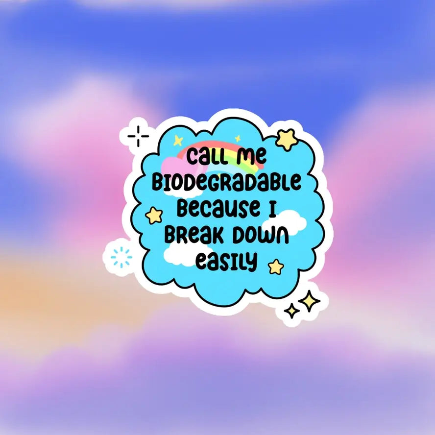 The blue Call Me Biodegradable Because I Break Down Easily 4" Vinyl Sticker on a pink and blue background.