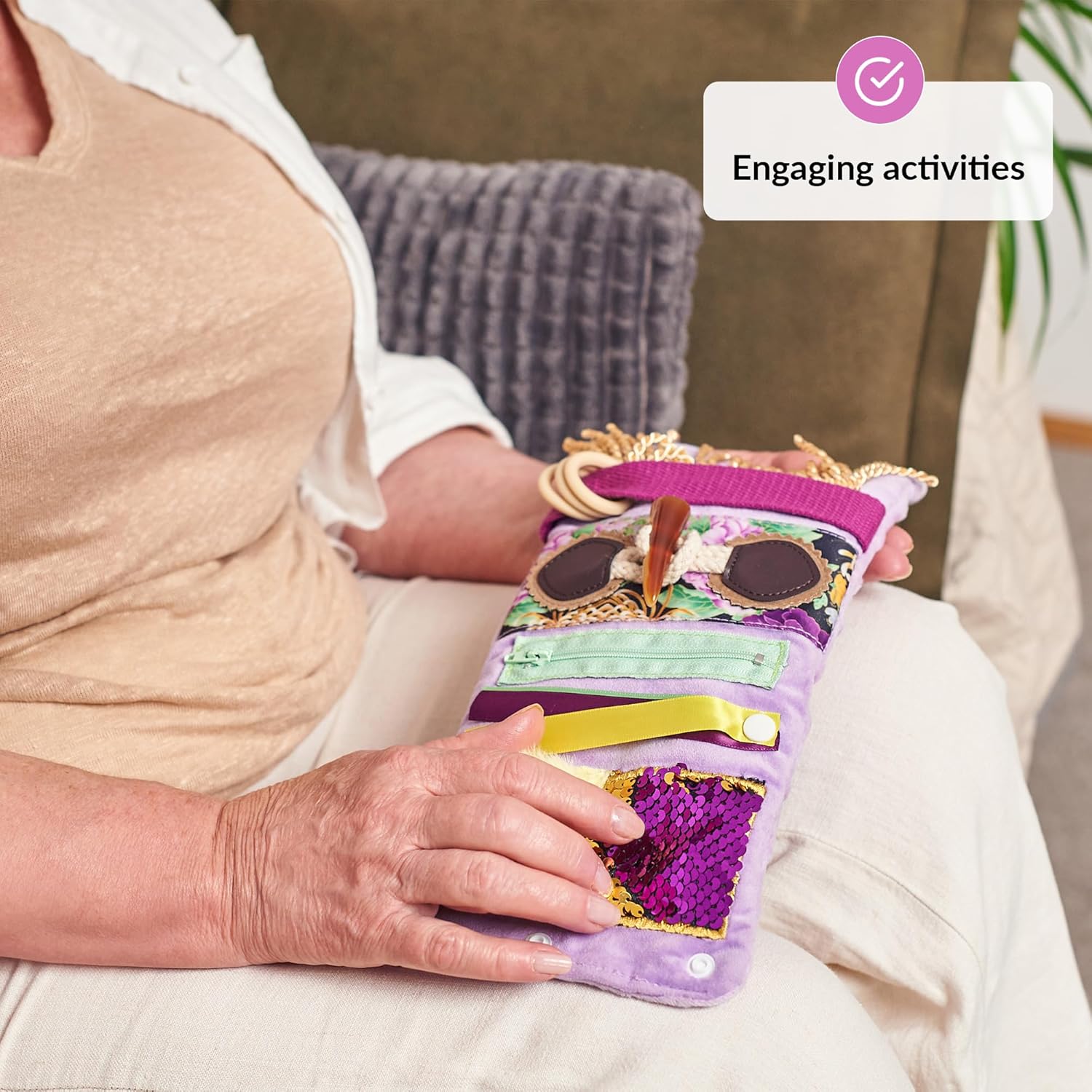 The Purple Fidget Wrist Cuff sits unfolded on someone's lap.