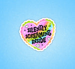 A heart shaped pastel sticker with black text that reads: Silently Screaming Inside.