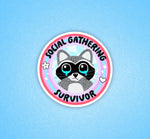 A circular sticker that has a raccoon with teary eyes. The text reads: Social Gathering Survivor.