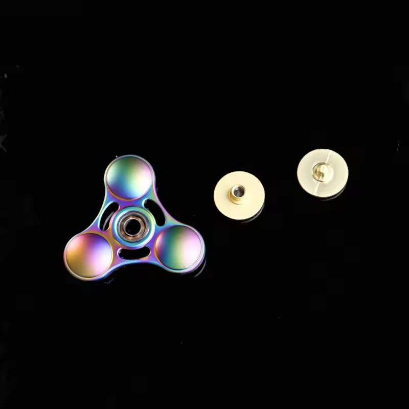 The Rainbow Metal Fidget Spinner is shown with the center piece removed, revealing the bearing.
