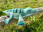 The 3 lb Weighted Alligator Plush from Roamin' Bison Workshop on a wooden fence.