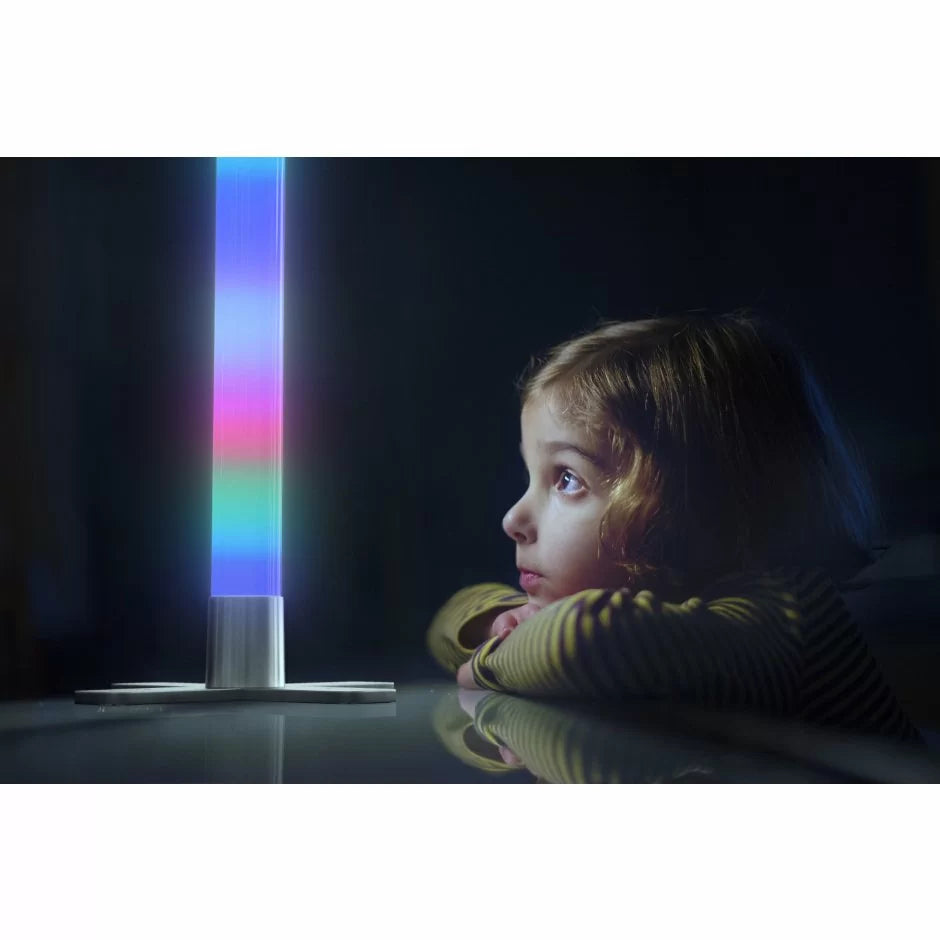 A child looks up at the LED Rocket Light Tube with Remote in a darkly lit room.