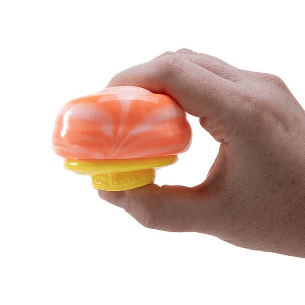 A hand squishes the orange Nee Doh Nice Cream Cone.