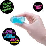 A hand squeezes the blue NeeDoh Nice Ice Baby.