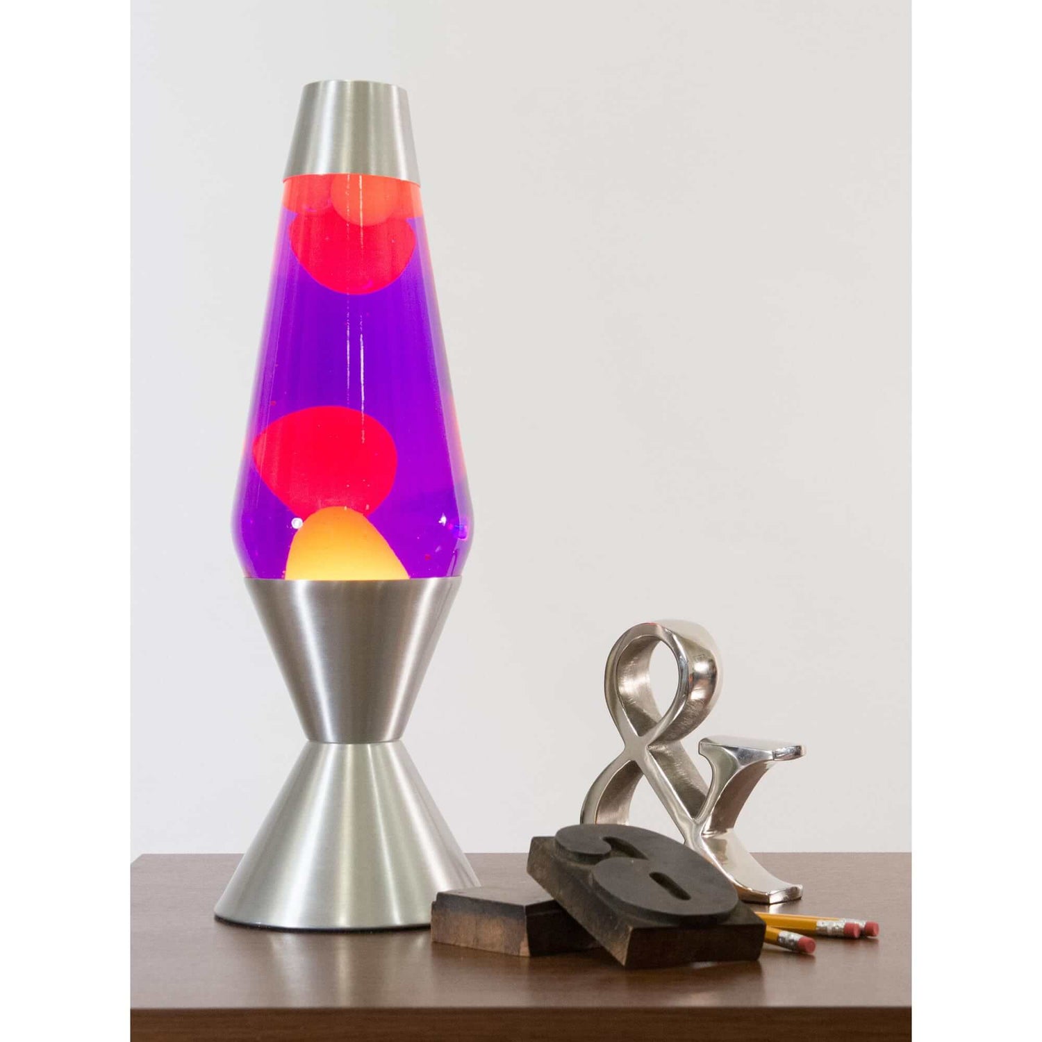 The 16.3" silver, yellow, and purple Lava Lamp next to several desk decorations.