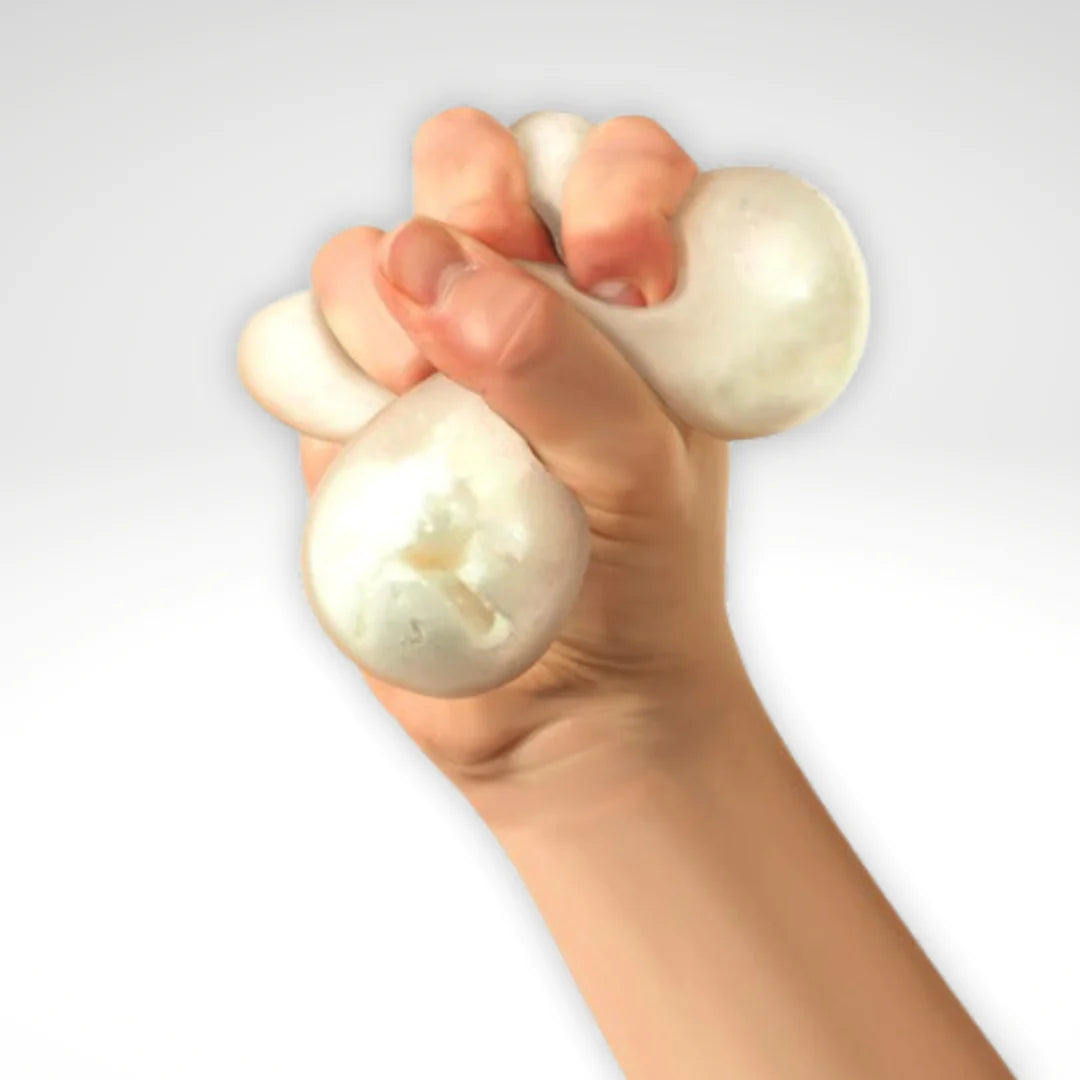 A hand with light skin tone squeezes the Snow Ball Crunch.