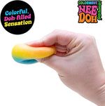 A hand squishes the rainbow Teenie Quad Squad NeeDoh.