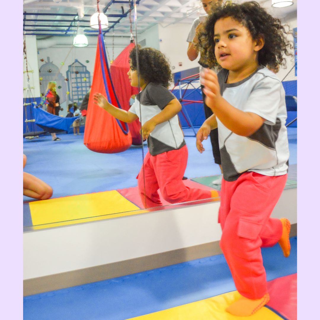 A child wears the coral Youth Sensory Friendly Fidget Jogger.