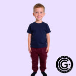 A child wearing the maroon Youth Sensory Friendly Fidget Jogger.
