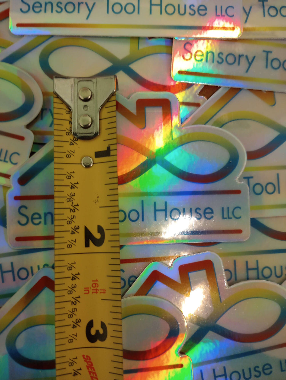 A measuring tape illustrating the dimensions of the Sensory Tool House Holographic Sticker.