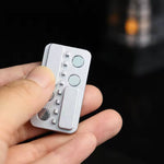 A hand holding the silver Magnetic Haptic Clicker Fidget.