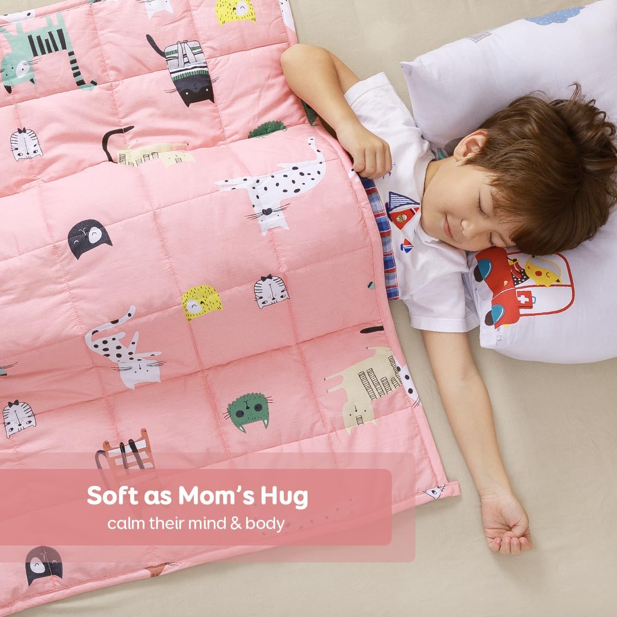 A child is sprawled out on the floor, sleeping under the Sivio Cotton Weighted Blankets for Kids.