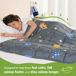 A child lays on their side underneath the Space Grey Washable Cooling Weighted Blanket - 5 lb.