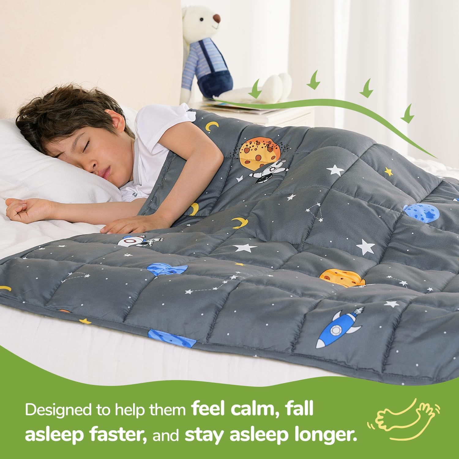 A child lays on their side underneath the Space Grey Washable Cooling Weighted Blanket - 5 lb.