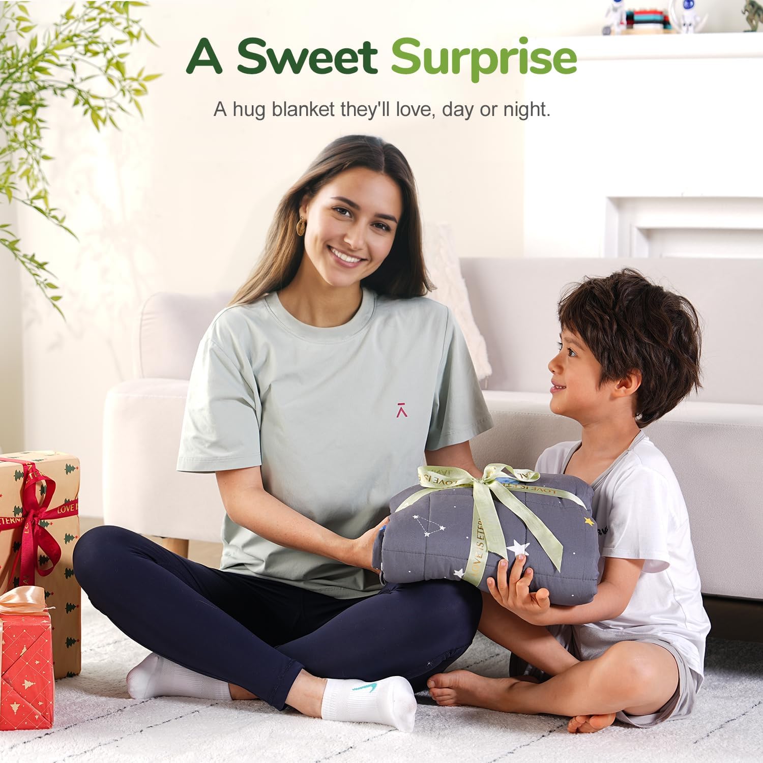 An adult hands the Space Grey Washable Cooling Weighted Blanket to a child.