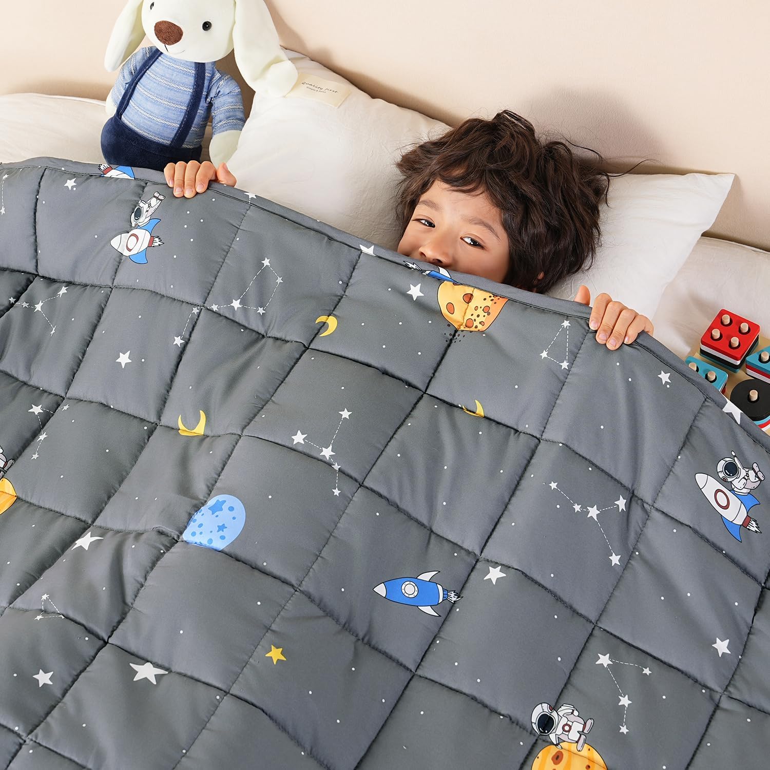 A child peaks their head out from the Space Grey Washable Cooling Weighted Blanket - 5 lb.