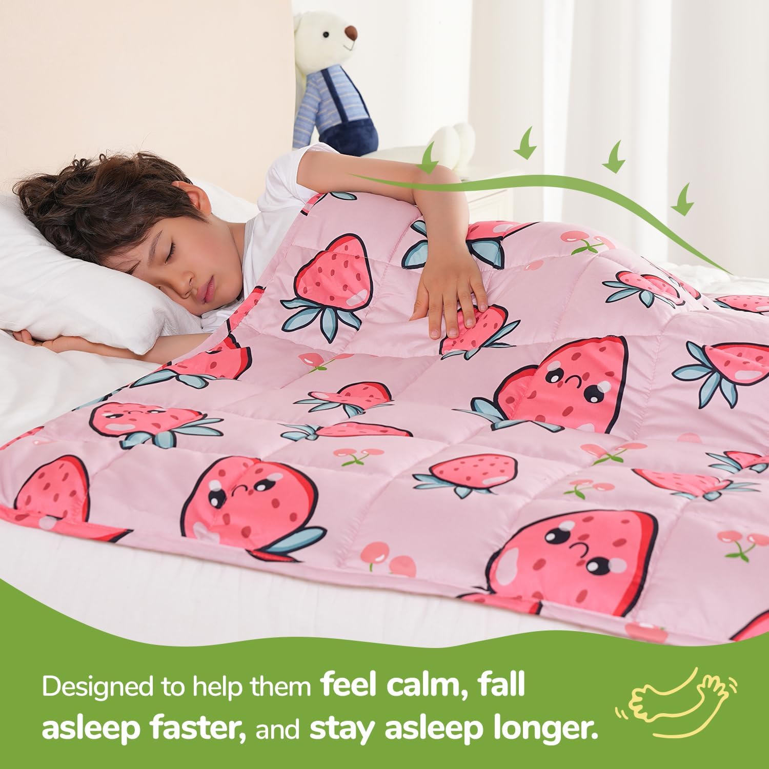 A child lays on their side underneath the 
Strawberry Washable Cooling Weighted Blanket for Kids - 5 lb.