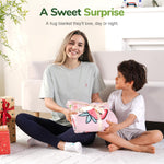 A child accepts the 
Strawberry Washable Cooling Weighted Blanket for Kids - 5 lb as a gift from an adult.