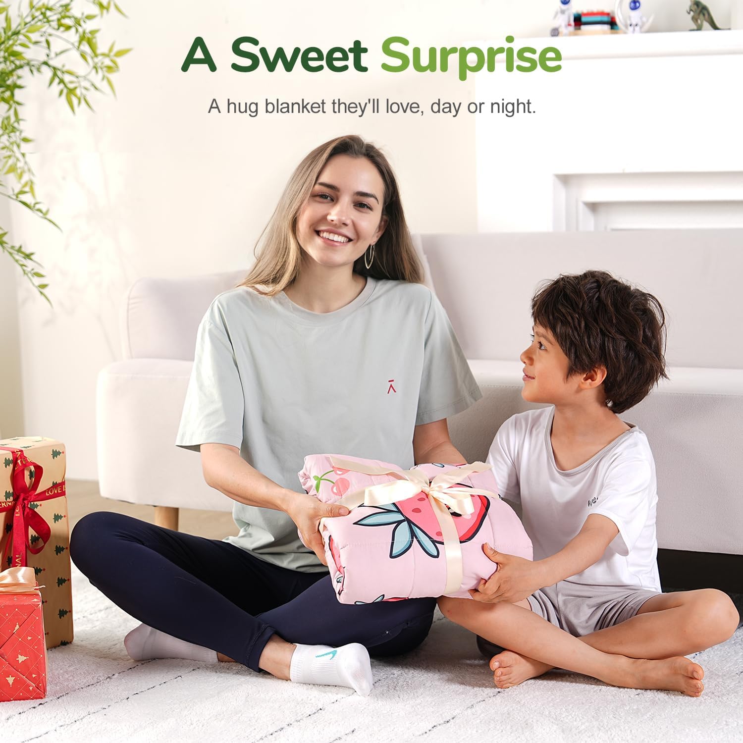 A child accepts the 
Strawberry Washable Cooling Weighted Blanket for Kids - 5 lb as a gift from an adult.