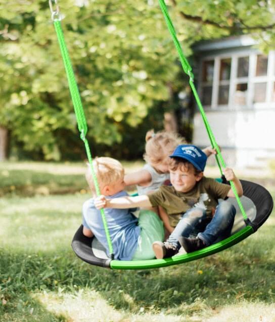 Three children ride on the 40" Adventure Sky Swing.