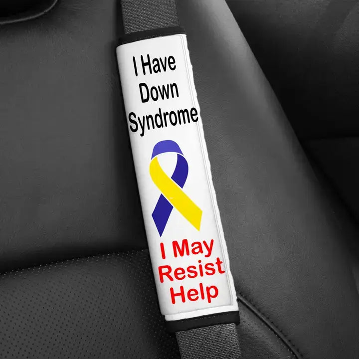 A seatbelt cover that says "I Have Down Syndrome, I May Resist Help."