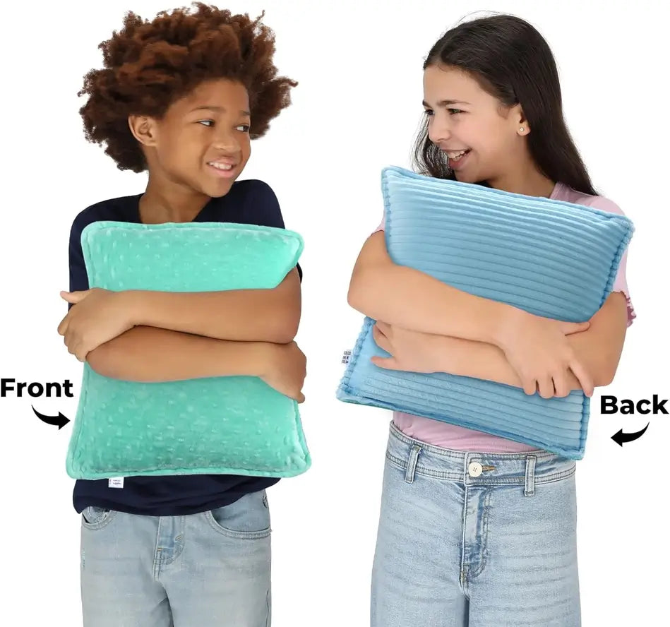 Two children squeeze two different Vibrating Pillows with two different sides facing the camera.