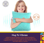 A child holds up the Vibrating Pillow as they smile.