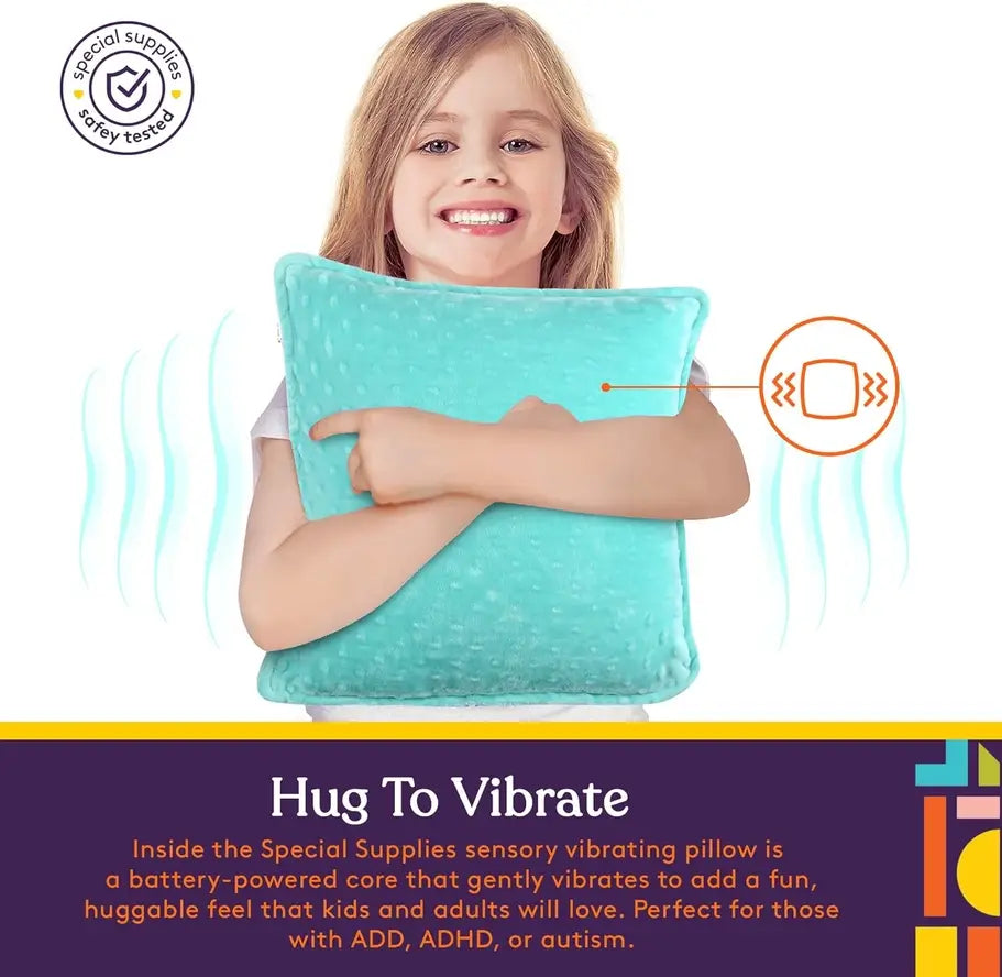 A child holds up the Vibrating Pillow as they smile.