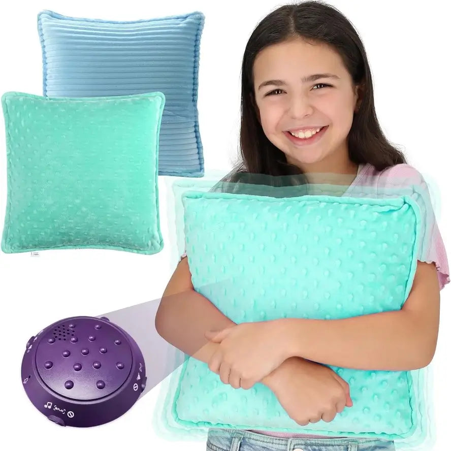 A child holds the Vibrating Pillow up to their chest while smiling.