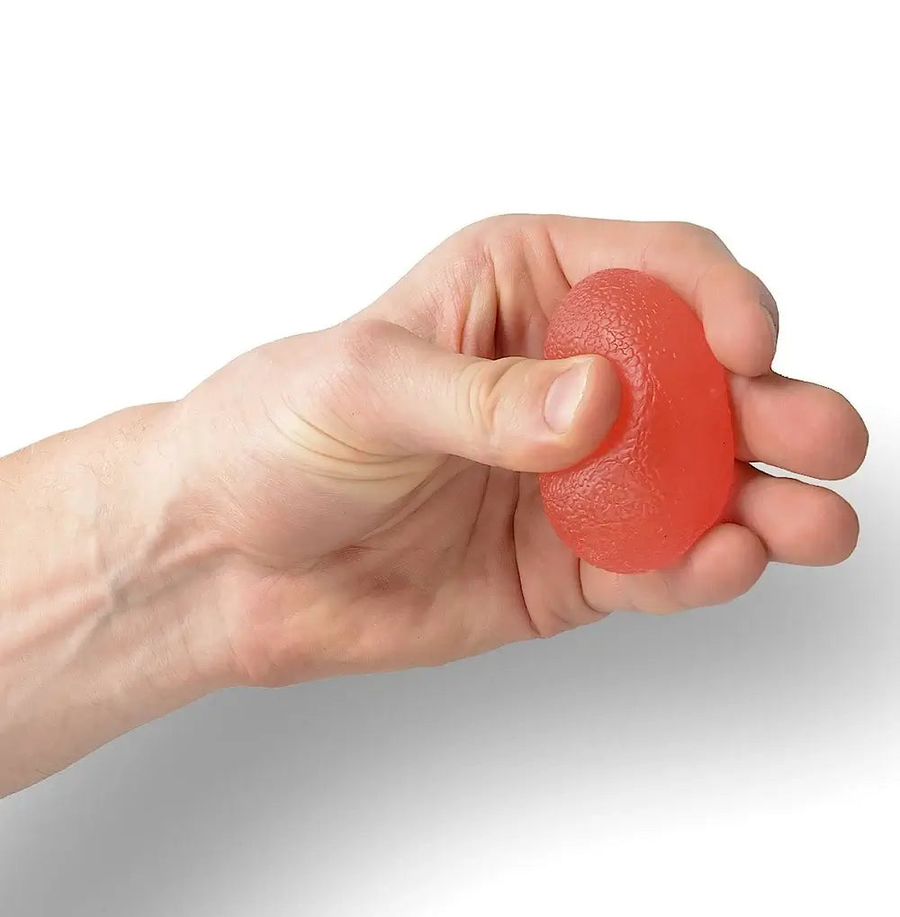 A hand squeezes the red Hand and Finger Grip Strenghener Egg Shaped Stress Ball.