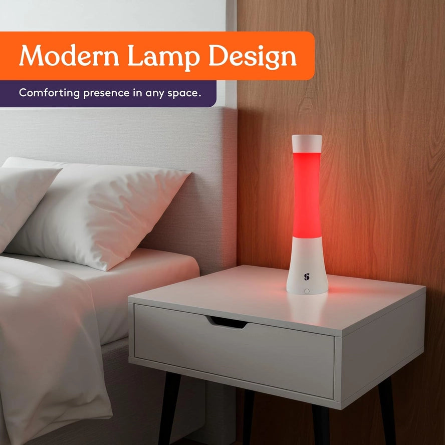 The Special Supplies Light Lava Lamp glows red on a bedside table.