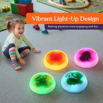 A child sits next to the lit up Special Supplies Round Liquid Gel LED Stepping Stones - 4-pack.