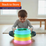 A child stacks the Special Supplies Round Liquid Gel LED Stepping Stones - 4-pack.