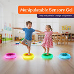 Two children step on the Special Supplies Round Liquid Gel LED Stepping Stones - 4-pack. 