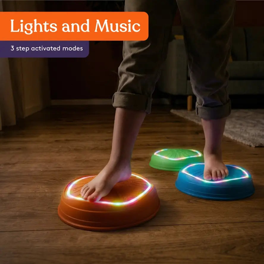 The Musical LED Stepping Stones are lit up in a dim room.
