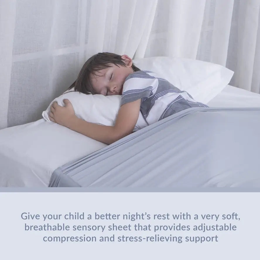 A child hugs their pillow while sleeping underneath the Grey Queen Sized Compression Bed Sheet.