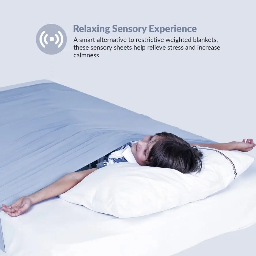 A child lies on their backside with their arms stretched out underneath the Grey Queen sized Compression Bed Sheet.