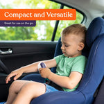 A child uses the Sensory Brush with Handle while in a car seat.