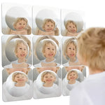 A child looks into 9 pieces of the Sensory Bubble Wall Mirror.