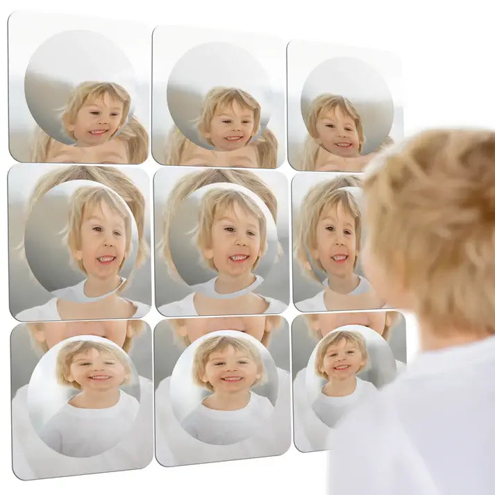 A child looks into 9 pieces of the Sensory Bubble Wall Mirror.