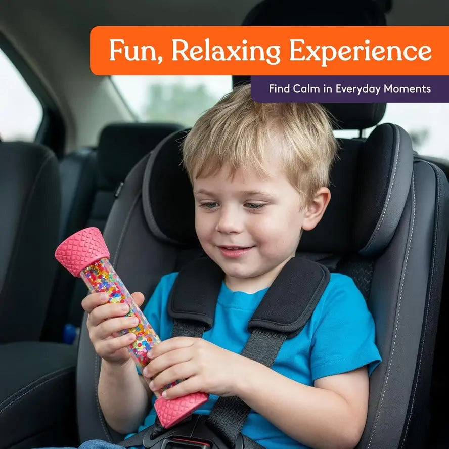 A child holds a Textured Sensory Tube while in a child seat.
