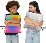 Two children hold different sides of the Dual Sided Vibrating Pillow - Rainbow & Grey.