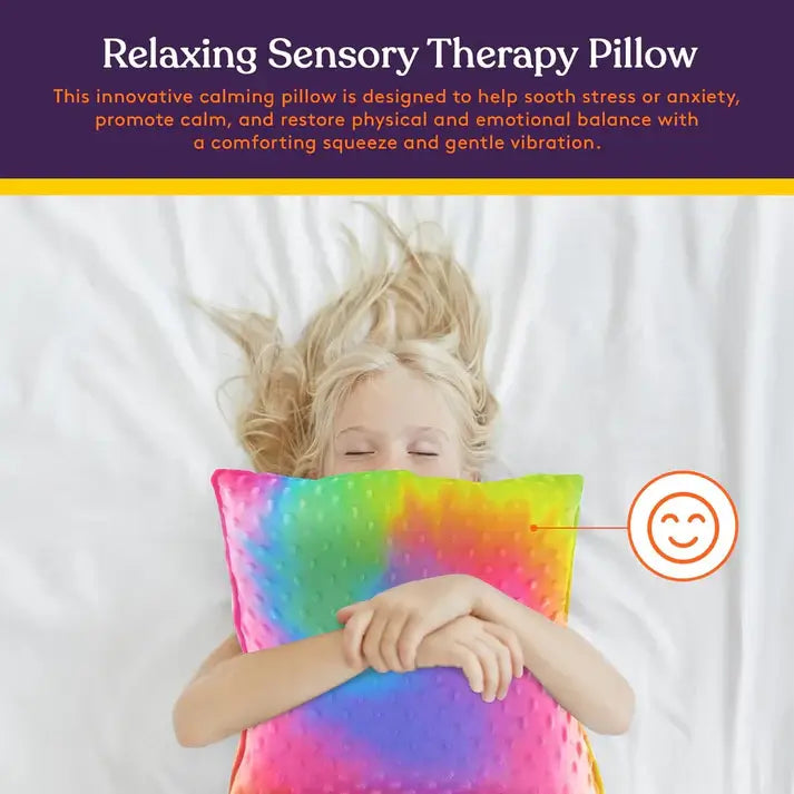 A child lays down and hugs the Dual Sided Vibrating Pillow.