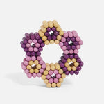 A 3D flower design made from Speks 432 Fidget Magnets - Bold Mix, Sassy.