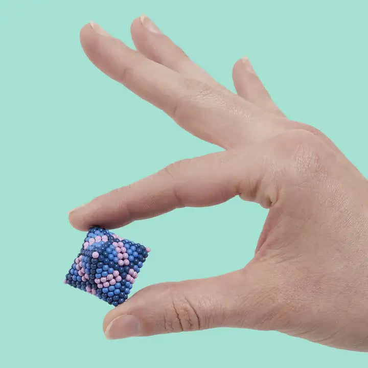 A hand holds a design made by the Speks 432 Fidget Magnets - Bold, Valiant.