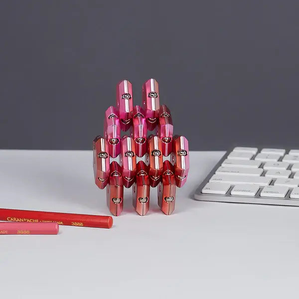 Pieces of the Stellar Speks Geode Chrome are stacked in a design.