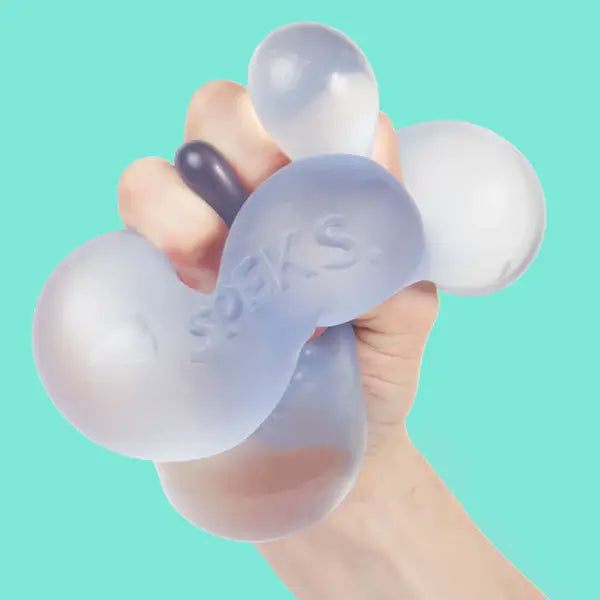 A hand squishes the Dew Speks Gump Jumbo Gel Stress Ball.