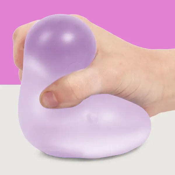 A hand squishes the Mist Speks Gump Jumbo Gel Stress Ball.